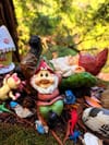 Group of garden gnomes and figurines on moss with leaves
